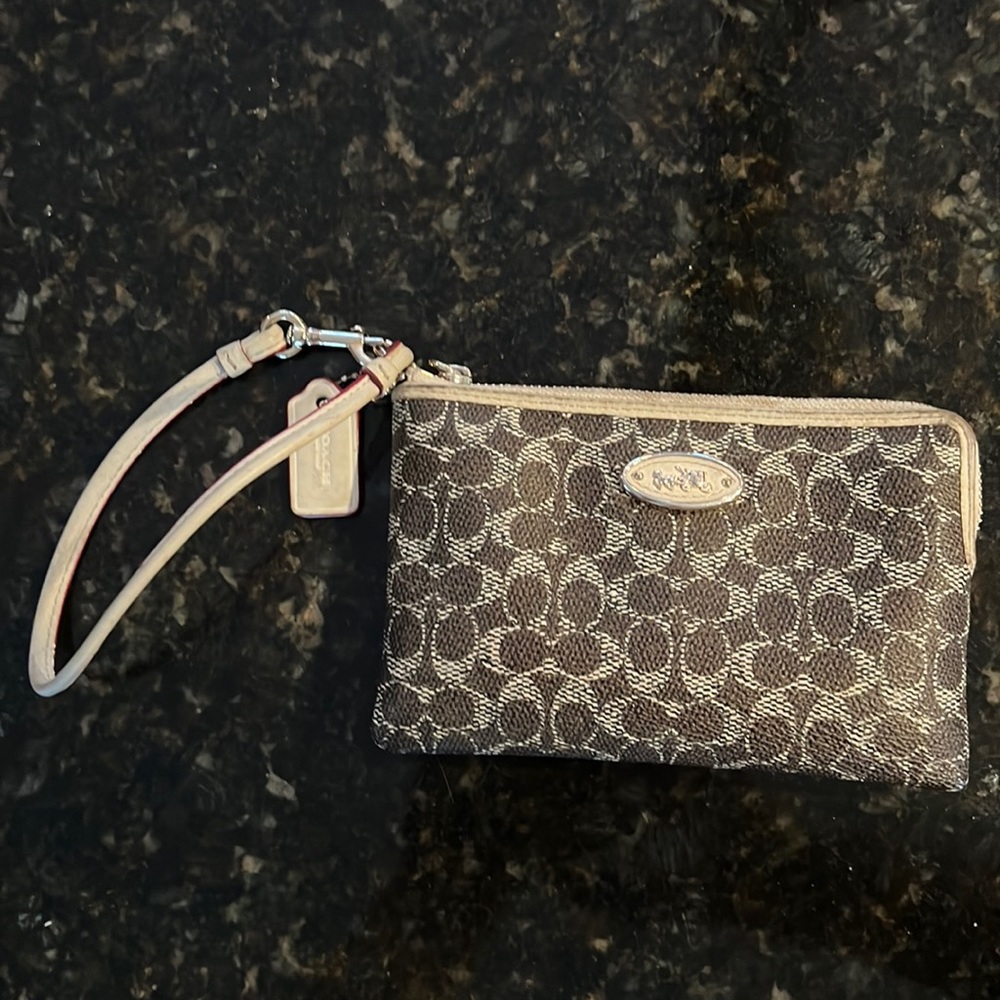 Women’s dark brown/tan classic wristlet in excellent condition. Inside/two slots